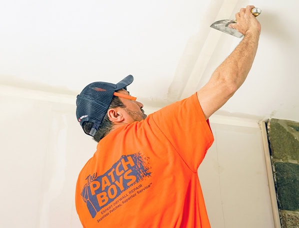 Patch Boys worker repairing ceiling
