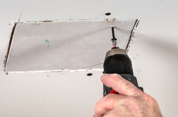 Close up of drywall being repaired