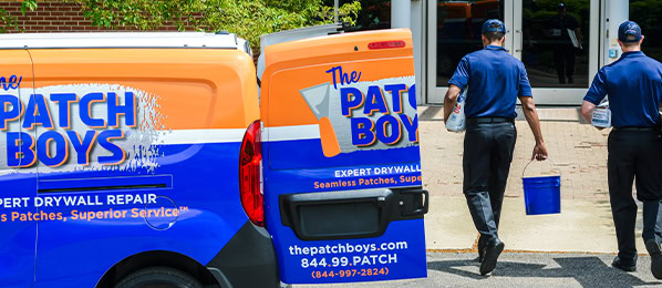 Technicians carrying tools from van