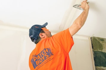 Patch Boys worker repairing ceiling