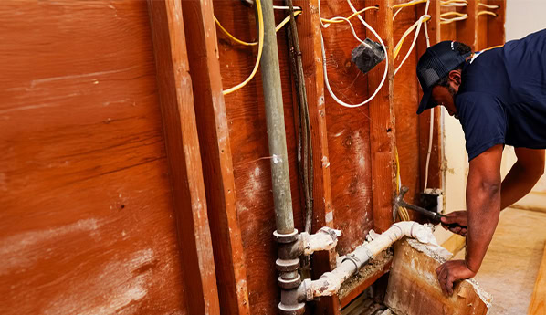 Patch Boys technician installing insulation.
