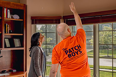 Technicion pointing to ceiling with customer
