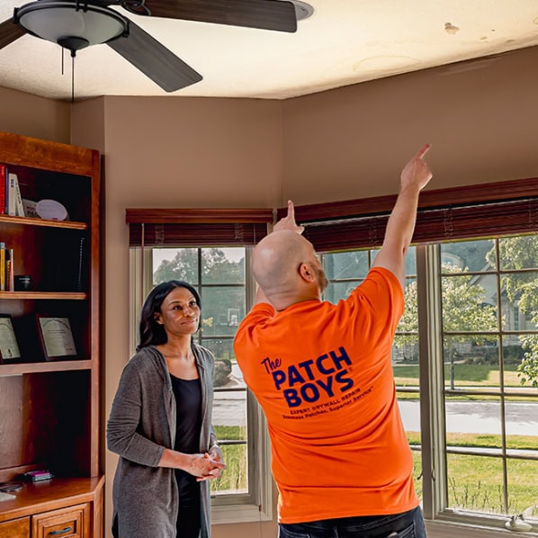 worker inspecting ceiling repair
