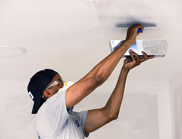 Patch Boys technician applying texture to ceiling