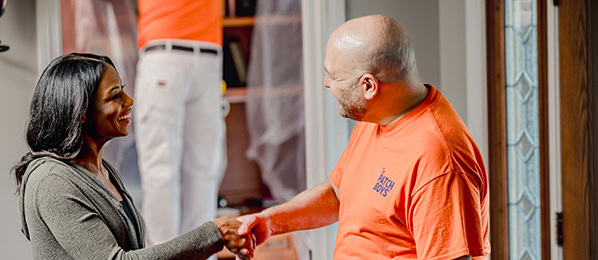 Worker shaking hands with customer